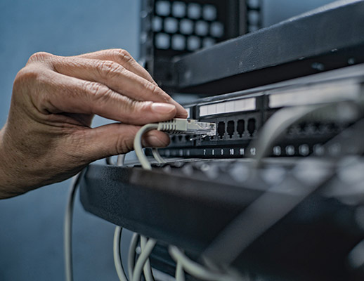 IT expert hooking up network switch to optimize inbound and outbound traffic