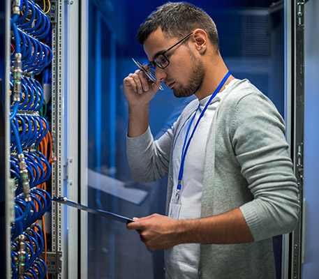 IT Engineer working with supercomputer to optimize business network