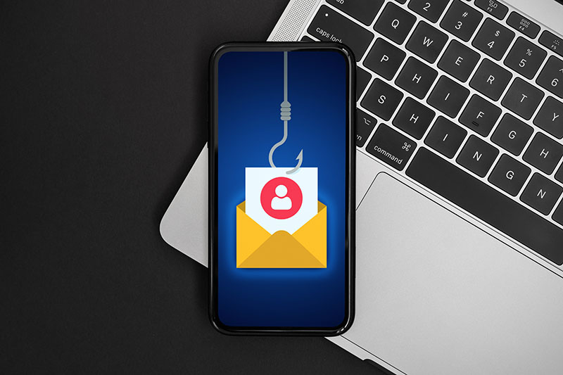 Fishing hook through email icon as phishing cybersecurity attack concept